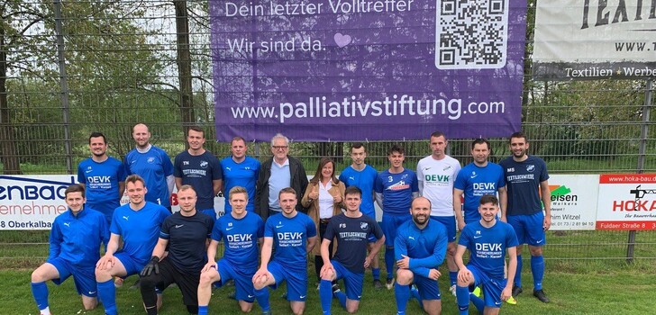 Die SG Kerzell mit Vorstandssprecher Claus Heiner und Palliativ-Geschäftsführerin Elke Hohmann (hintere Reihe, Bildmitte) bei der Präsentation des neuen Banners.
